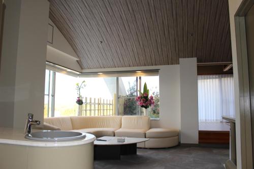 a living room with a couch and a table at The Gran Resort Princess Arima in Kobe