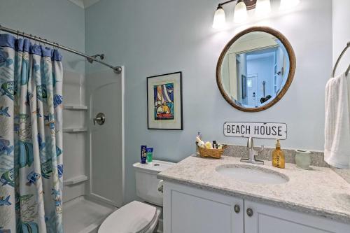 a bathroom with a sink and a toilet and a mirror at Harbor Oaks Haven Walk to Front Beach and Downtown! in Ocean Springs