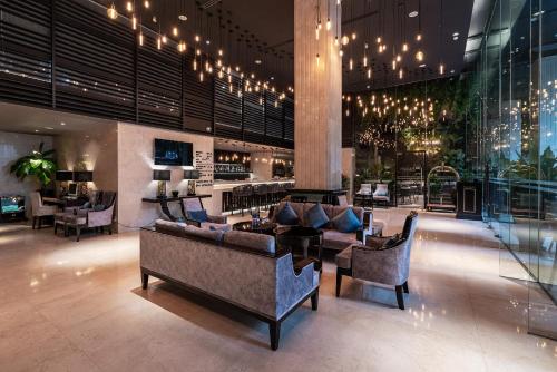 Un vestíbulo con sofás y sillas en un edificio. en Paragon Saigon Hotel, en Ho Chi Minh