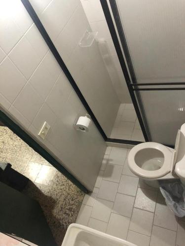 a bathroom with a toilet and a sink at Casa Quinta Guatape in Guatapé