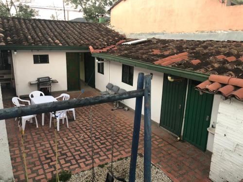 an outside view of a house with a table and chairs at Casa Quinta Guatape in Guatapé