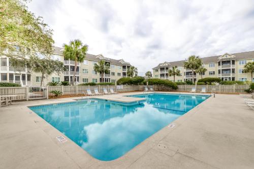 a swimming pool in the courtyard of a apartment building at Port O'Call C-303 in Isle of Palms