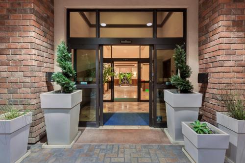 an entrance to a building with two potted plants at Holiday Inn Express Hotel & Suites Atascadero by IHG in Atascadero