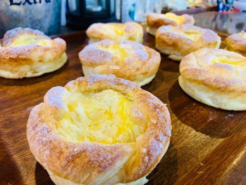 a bunch of pastries sitting on a wooden table at Ma-Blue Garden House in Motobu