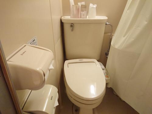 a small bathroom with a toilet and a sink at Residence Hotel Will Shinjuku in Tokyo