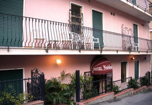a hotel room with a balcony overlooking the ocean at Hotel Natalina in Taormina
