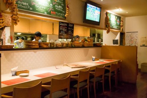 a restaurant with a long table with chairs in it at Hotel Resol Trinity Sapporo in Sapporo