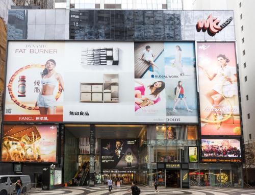 a building with large advertisements on the side of it at Holiday Inn Express Hong Kong Causeway Bay by IHG in Hong Kong