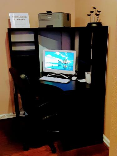 a desk with a laptop computer on top of it at GuestHouse Inn Enumclaw in Enumclaw