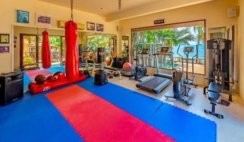 a fitness room with a gym with a red and blue carpet at Sibaja Palms Sunset Beach Luxury Apartments in Taling Ngam Beach