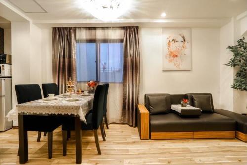 uma sala de jantar com uma mesa e um sofá em 大阪之家 心斋桥难波附近4室一厅整套房子5 可接送机场 em Osaka