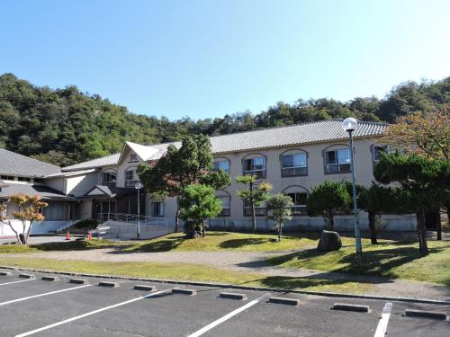 a building with a parking lot in front of it at The Gran Resort Kinosaki in Toyooka