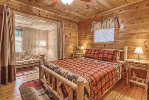 a bedroom with a bed in a log cabin at Bear Den in Sevierville