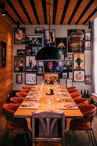 a large table in a restaurant with chairs and posters at Vienna House Easy by Wyndham München in Munich