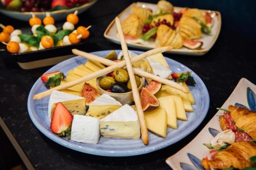 a plate of cheese and other appetizers on a table at Vienna House Easy by Wyndham München in Munich