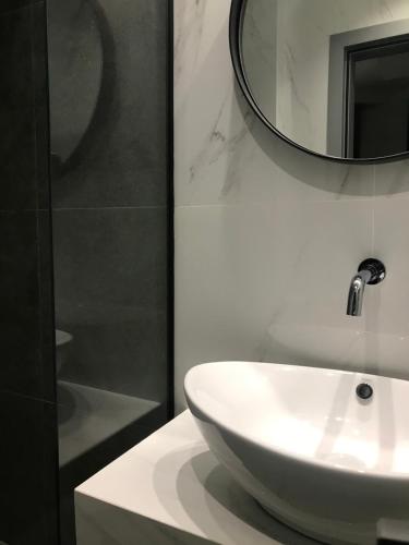 a bathroom with a white sink and a mirror at Anessis in Thessaloniki