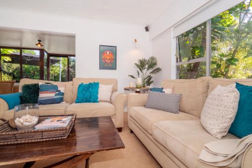 a living room with two couches and a coffee table at Patton's Place - Pauanui Holiday Home in Pauanui