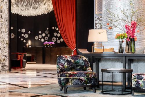 a living room with a chair and a table at Jumeirah Guangzhou - Complimentary Shuttle Bus to Canton Fair Complex in Guangzhou