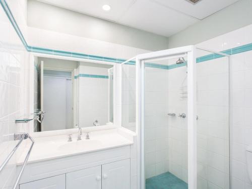 a bathroom with a sink and a shower at Castillo Del Mar 10 in Tuncurry