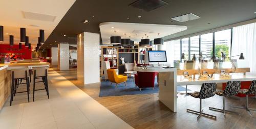 a store with chairs and tables in a building at Holiday Inn Amsterdam - Arena Towers by IHG in Amsterdam