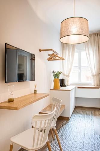 a dining room with two chairs and a table and a tv at Dimora Labbate in Polignano a Mare