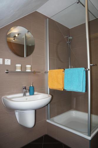 uma casa de banho com um lavatório, um espelho e uma banheira em Villa Wilhelmina em Hemmoor