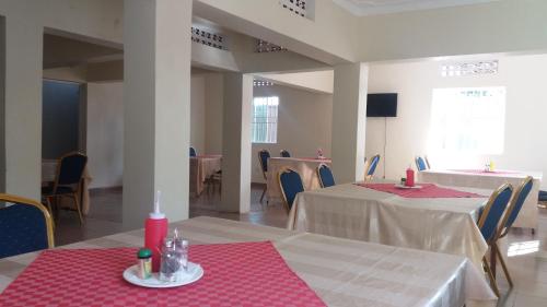 GuluDich Comfort Hotel University Branch的一间用餐室,配有两张红色和白色桌布桌