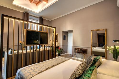 a bedroom with a bed and a mirror at Tree Charme Parliament Boutique Hotel in Rome