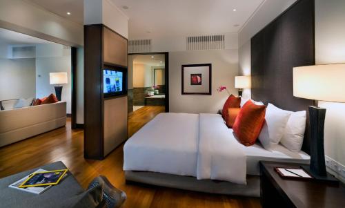 a bedroom with a large white bed and a flat screen tv at The Saujana Kuala Lumpur in Subang Jaya
