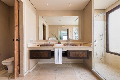 a bathroom with two sinks and a mirror at Villas Alondra in Puerto del Carmen