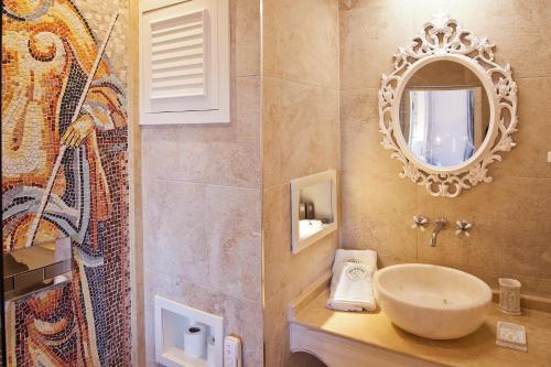 a bathroom with a sink and a mirror at Vinifera Ephesus Hotel in Selçuk