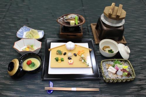 a table with a plate of food and chopsticks at The Gran Resort Princess Arima in Kobe