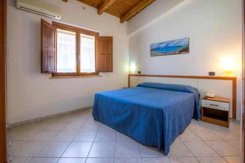 En eller flere senger på et rom på Arcomagno Beach Resort