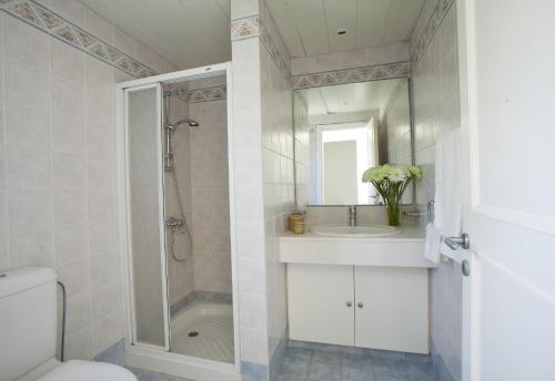a bathroom with a shower and a sink and a toilet at Ayios Elias Pearl in Protaras