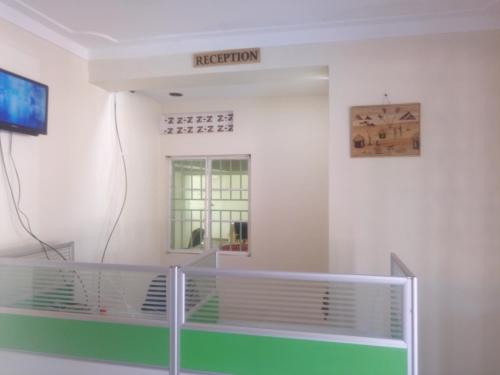 a hospital room with a detection sign on the wall at Dich Comfort Hotel University Branch in Gulu