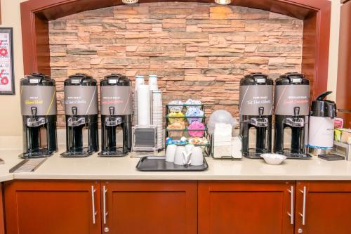 eine Theke mit einer Reihe von Kaffeemaschinen darauf in der Unterkunft Staybridge Suites Houston - IAH Airport by IHG in Houston