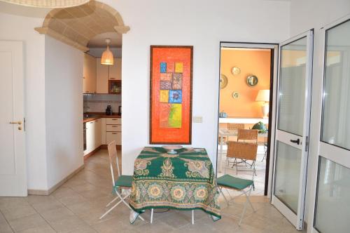 a kitchen and dining room with a table and chairs at Villa 19 in Santa Cesarea Terme