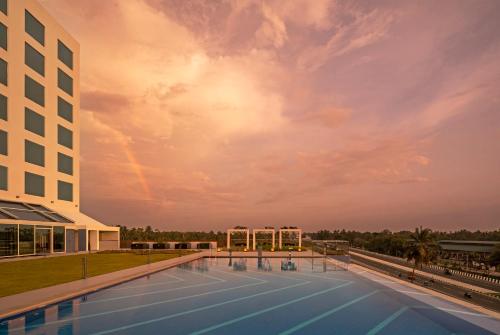 a pool on the roof of a building at O by Tamara, Trivandrum in Trivandrum