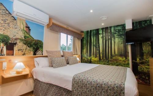 a bedroom with a bed and a large window at Magic Robin Hood in Albir