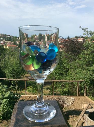 a wine glass filled with marbles sitting on a table at GUEST HOUSE DAVID in Sighnaghi