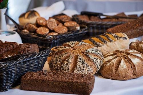 a table topped with lots of different types of bread at Konventum Conference Center in Helsingør