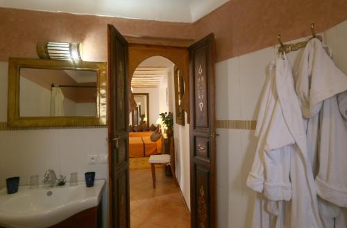 a bathroom with a sink and a mirror at Riad Karmela in Marrakesh