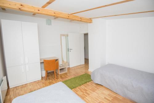 a bedroom with a bed and a chair and a desk at Kuće za odmor -Japin breg in Ðurđevac