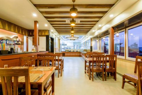 a restaurant with wooden tables and wooden chairs at Thamel Boutique Hotel in Kathmandu