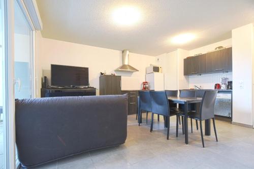 a kitchen and dining room with a table and chairs at Beautiful Bright Apt With Terrace in Lyon