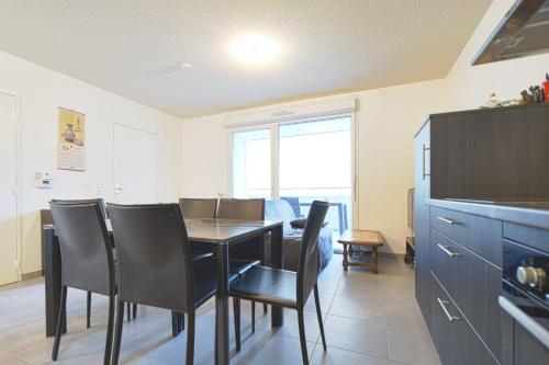a dining room with a table and chairs at Beautiful Bright Apt With Terrace in Lyon