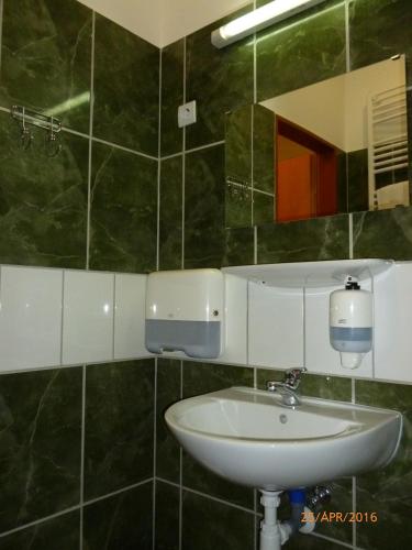 a bathroom with a sink and a mirror at Mátraházai Üdülőház in Mátraháza