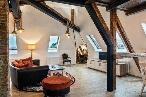an attic living room with exposed beams at Apartament The Bricks 1903 in Bistriţa