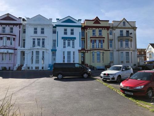 a group of cars parked in front of a large building at Five Way Apartments in Paignton