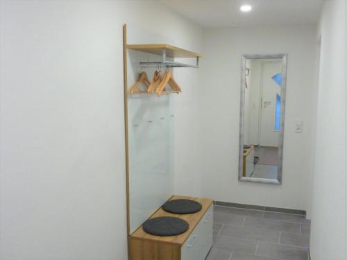 a bathroom with a counter with a mirror and a sink at Ferienwohnung Haisterkirch in Bad Waldsee